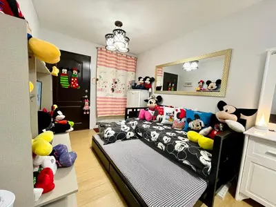 a bedroom with a bed with stuffed animals on it at Staycation with Mickey & Minnie One Oasis Pasig in Manila