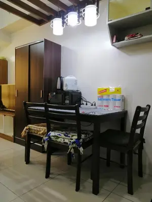 a kitchen with a table with two chairs and a telephone at Studio Unit at The Beacon Makati in Manila