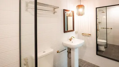 a bathroom with a sink and a toilet at MIRANAMIN NEST Elegant Home, Indoor Plunge Pool, Pet-Friendly, with Rooftop, Kitchens, Self-Service Breakfast - Ideal for Reunions, Team Building, Intimate Gatherings in Manila