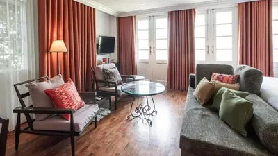 a living room with a couch and chairs and a table at MIRANAMIN NEST Elegant Home, Indoor Plunge Pool, Pet-Friendly, with Rooftop, Kitchens, Self-Service Breakfast - Ideal for Reunions, Team Building, Intimate Gatherings in Manila
