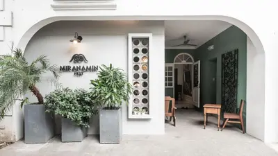 an entrance to a house with potted plants at MiraNamin Nest BANABA - Garden View Suite in Historic Home - Bathtub, Luxury Indoor Plunge Pool, Guest Kitchen, Self-Service Breakfast, Rooftop, Pet-Friendly in Manila