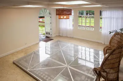a living room with a glass floor at MiraNamin Nest BANABA - Garden View Suite in Historic Home - Bathtub, Luxury Indoor Plunge Pool, Guest Kitchen, Self-Service Breakfast, Rooftop, Pet-Friendly in Manila