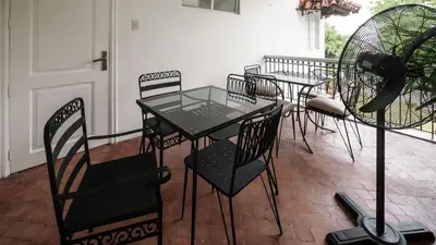 a table and chairs sitting on a patio at MiraNamin Nest KAMANTIGI - Two Bed Suite in Historic Home with Luxury Indoor Plunge Pool, Garden Access, Self-Service Breakfast, Guest Kitchen, Pet-Friendly in Manila
