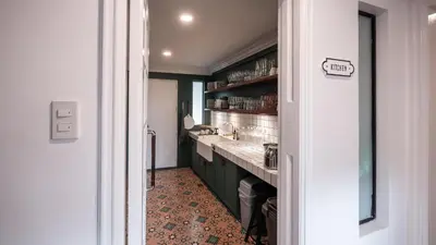 a kitchen with green cabinets and a sink at MiraNamin Nest KAMANTIGI - Two Bed Suite in Historic Home with Luxury Indoor Plunge Pool, Garden Access, Self-Service Breakfast, Guest Kitchen, Pet-Friendly in Manila
