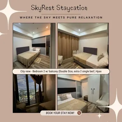 a screenshot of a hotel room with two beds at Skyrest Staycation - Azure Urban Resort in Manila