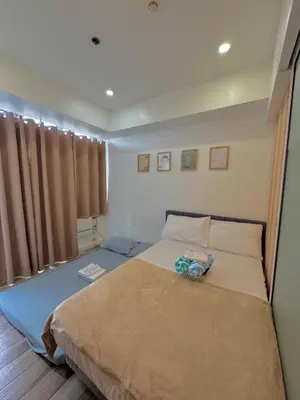 a bedroom with a large bed in a room at Skyrest Staycation - Azure Urban Resort in Manila