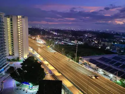 a view of a city at night with traffic at Skyrest Staycation - Azure Urban Resort in Manila