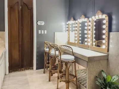 a row of stools at a bar with a mirror at MiraNamin Nest LIRYO - Family Suite in Unique Historic Home with Indoor Plunge Pool, Garden Access, Self-Service Breakfast, Guest Kitchen in Manila
