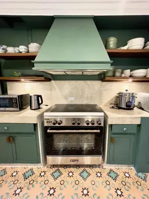 a kitchen with a stove with a green hood at MiraNamin M A P I L I G - Private Suite in Historic Home with Unique View, Self-Service Breakfast, Indoor Plunge Pool, Rooftop, Shared Kitchen in Manila