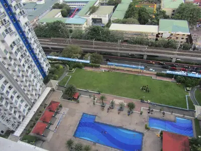 an aerial view of a park in a city with a train at SM MEZZA 1 RESIDENCES Studio Room Gian Thyresse Crib in Manila