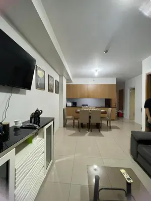 a living room with a couch and a dining room at 4kys staycation in Manila