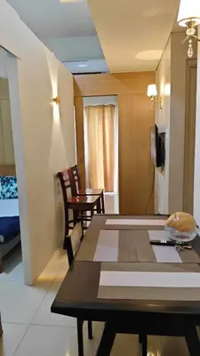 a room with a table and a room with a bed at 4kys staycation in Manila