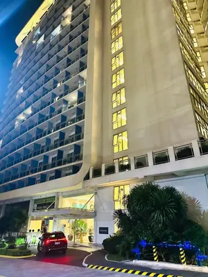 a car parked in front of a large building at We Vibe, Azure Urban Resort Residences in Manila