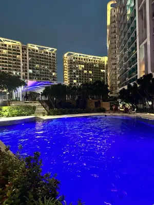 a large pool of blue water in front of buildings at We Vibe, Azure Urban Resort Residences in Manila