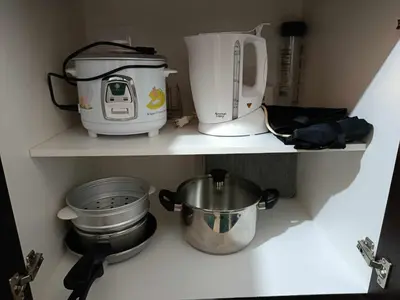 a kitchen shelf with some appliances on it at Urban Metro Escape in Pasig City in Manila