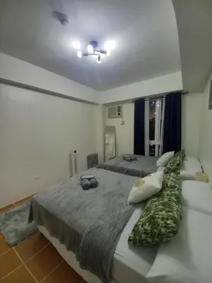 a bedroom with two beds at Urban Metro Escape in Pasig City in Manila