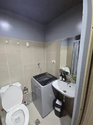 a small bathroom with a toilet and a sink at Shore Residences Cozy oasis by Richnells Tower D in Manila