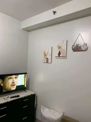 a flat screen tv sitting on top of a dresser at VSV Luxury Family suits Moa staycation in Manila