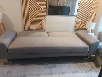 a couch in a room with a tv on a wall at LuxeStaysMnl Cozy Japandi Netflx Pool 400mbps in Manila