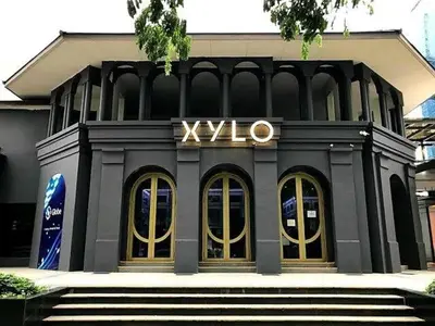 a black building with a xlvo sign on it at LuxeStaysMnl Cozy Japandi Netflx Pool 400mbps in Manila