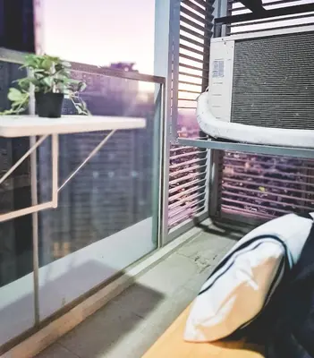 a room with a balcony with a microwave and a window at LuxeStaysMnl Cozy Japandi Netflx Pool 400mbps in Manila