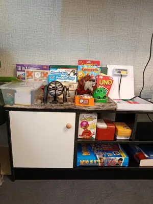 a table with books and games on it at Spacious Staycation in Pasig Urban Metro Escape in Manila