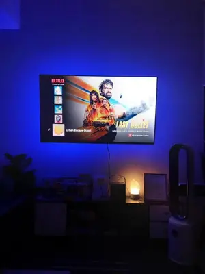 a flat screen tv in a room with a blue wall at Spacious Staycation in Pasig Urban Metro Escape in Manila