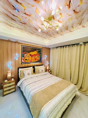 a bedroom with a bed with a flower ceiling at Miami suites in Manila