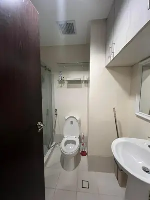 a bathroom with a toilet and a sink at Chelsea Tower 3 in Manila
