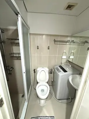 a small bathroom with a toilet and a sink at White House Staycation by Trixie Datiles in Manila