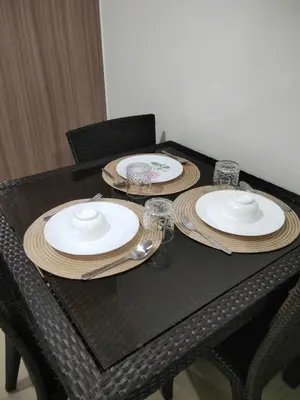 a black table with plates and glasses on it at Shore2 tower2 11th floor, unit 1122 VSV Luxury Family Suite staycation Moa in Manila