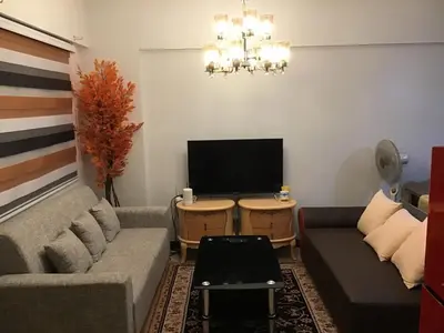 a living room with a couch and a flat screen tv at Alea Residences Condominium Casa Hayakawa in Manila