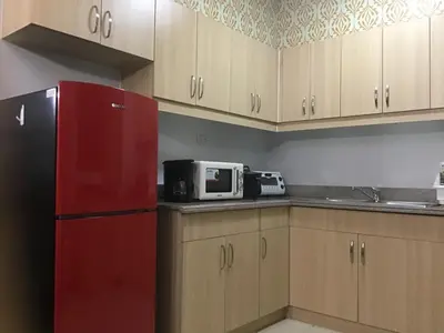 a kitchen with a red refrigerator and a microwave at Alea Residences Condominium Casa Hayakawa in Manila