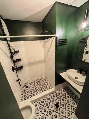 a bathroom with a shower and a sink and a toilet at Chelsea Tower 1 in Manila