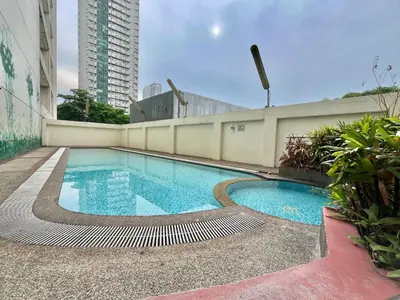 a swimming pool on the side of a building at A cozy condo within the center of Manila in Manila