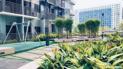 a park with a playground in front of a building at S-Residence Staycation Near IKEA,MOA,PICC in Manila