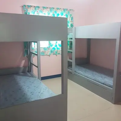 two bunk beds in a pink room with a mirror at Fazing in Bacoor