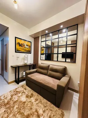 a living room with a couch and a table at RED RESIDENCES Makati in Manila