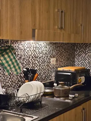 a kitchen counter with a sink and a microwave at Tokyo Oasis at Shore 1 Residences Tower A, Pasay, MOA in Manila