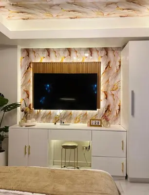 a living room with a tv on a wall at Paris Hilton Beach resort in Manila