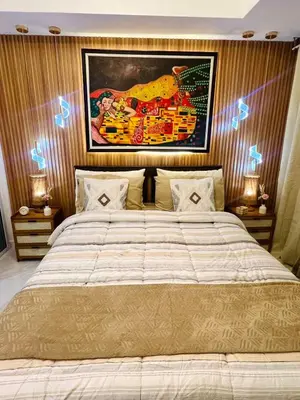 a bedroom with a large bed with lights on it at Paris Hilton Beach resort in Manila