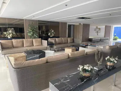 a large living room with couches and tables at Field Residences Condo Hotel Near Manila Airport in Manila