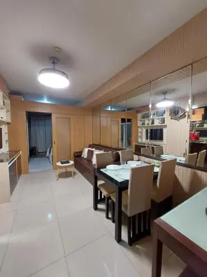 a kitchen and living room with a table and a couch at Executive Suite 519A at Shell Residence by GK Condotel in Manila