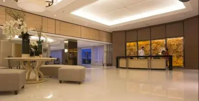 a lobby with a table and chairs in a building at Suite 1443D at Shell Residence by GK Condotel in Manila