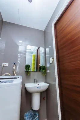 a bathroom with a sink and a toilet and a mirror at Secret Makati Love Haven Swim Gym Park Laugh 300MB in Manila