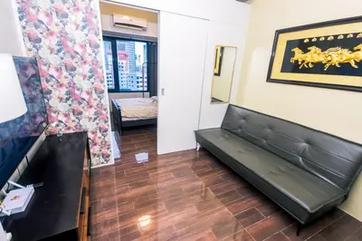 a living room with a couch in a room at Royal Polo club Air condo Makati Swim Gym Park 300 mbps in Manila