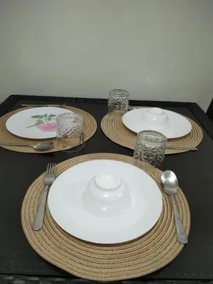 a table with three plates and glasses on it at VSV Luxury Family Suite staycation Moa shore2 tower2 unit1122 in Manila