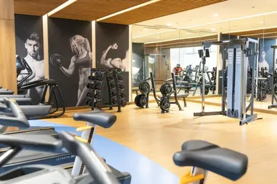 a gym with a bunch of tread machines in it at LUXX Suites McKinley with fast WIFI in BGC in Manila