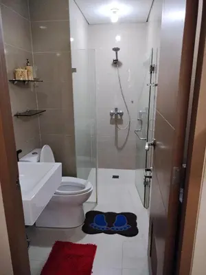 a bathroom with a shower and a toilet and a sink at Room Near Naia Terminal 3 and New World Resort in Manila