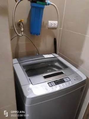 a washing machine sitting in a room with a charger at Room Near Naia Terminal 3 and New World Resort in Manila